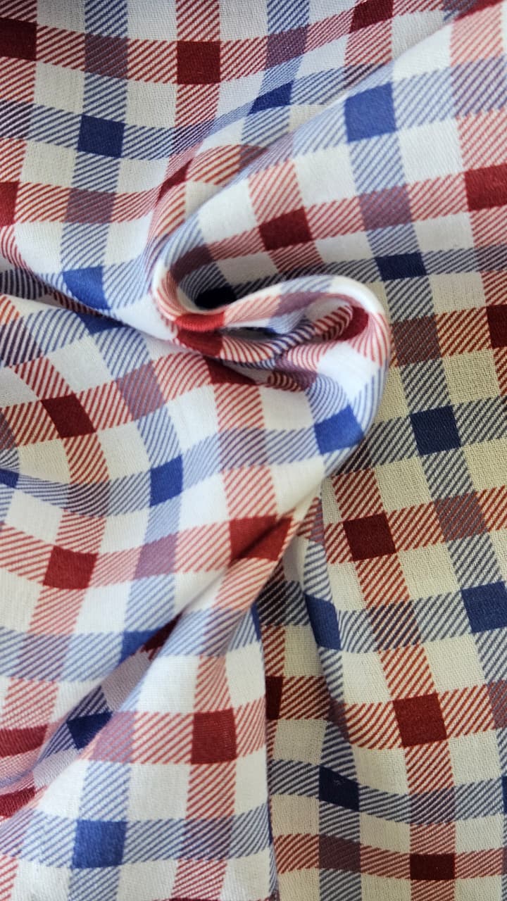 Close-up of soft, wrinkled pink cotton fabric displaying fine weave texture.