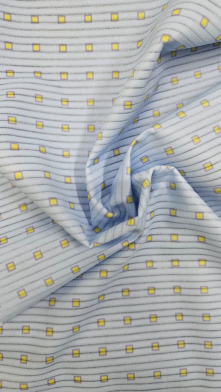 Close-up of soft, wrinkled pink cotton fabric displaying fine weave texture.