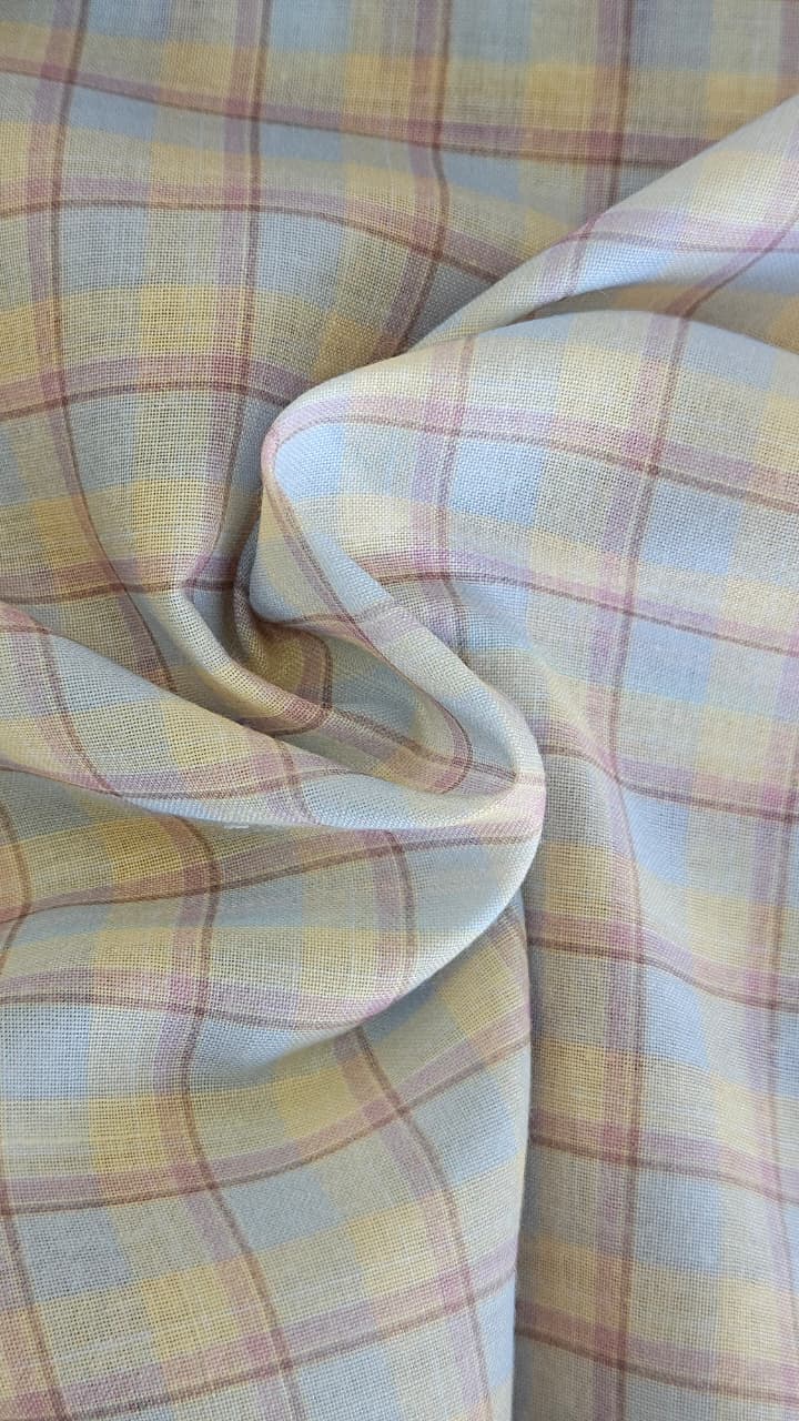 Close-up of soft, wrinkled pink cotton fabric displaying fine weave texture.