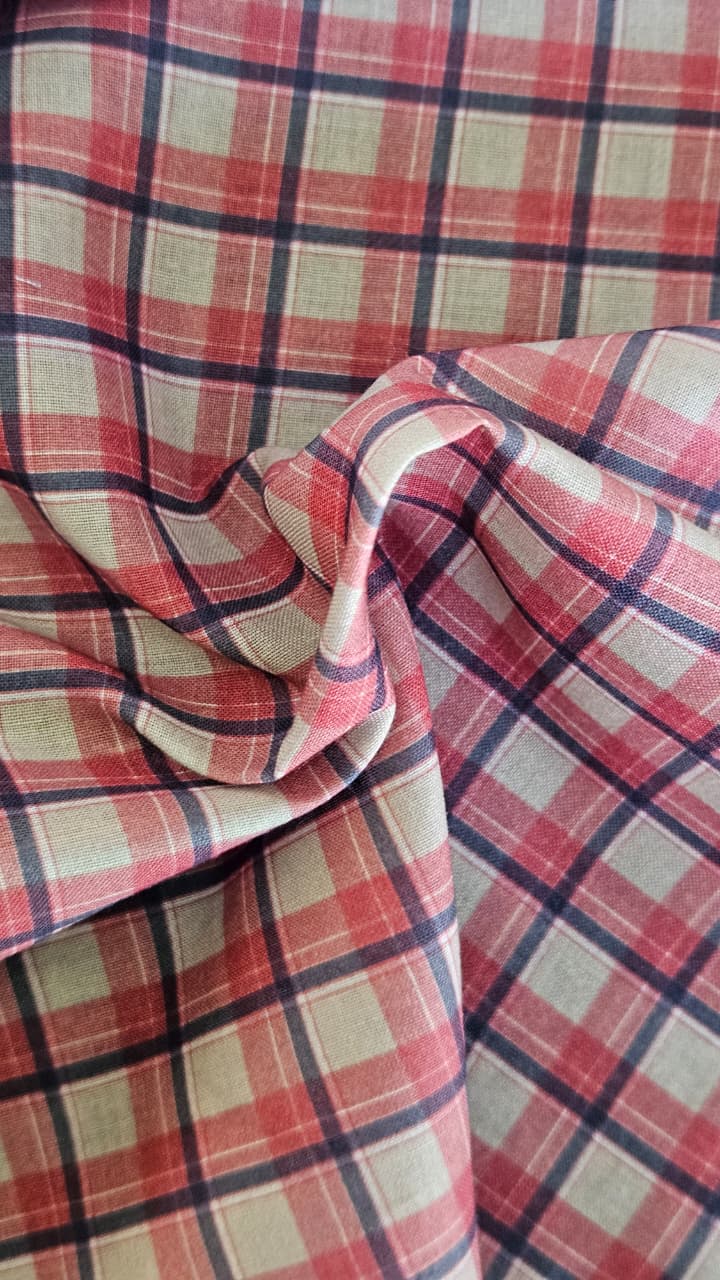 Close-up of soft, wrinkled pink cotton fabric displaying fine weave texture.