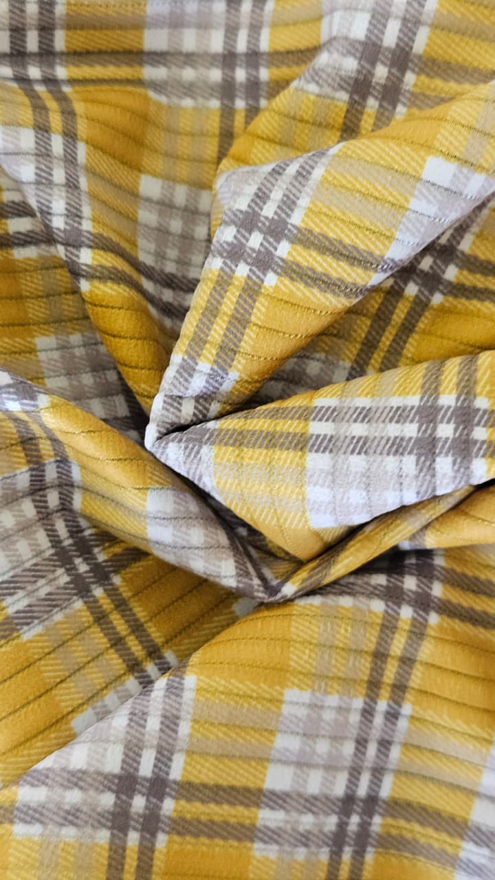 Close-up of soft, wrinkled pink cotton fabric displaying fine weave texture.