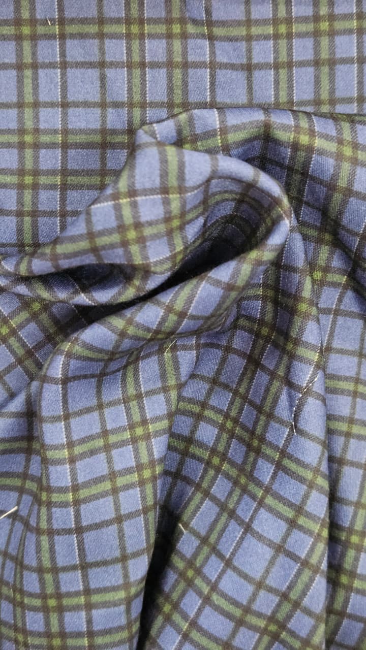Close-up of soft, wrinkled pink cotton fabric displaying fine weave texture.