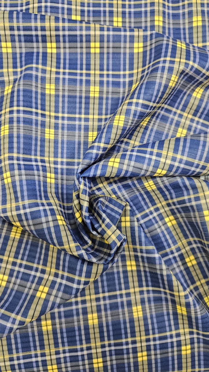 Close-up of soft, wrinkled pink cotton fabric displaying fine weave texture.