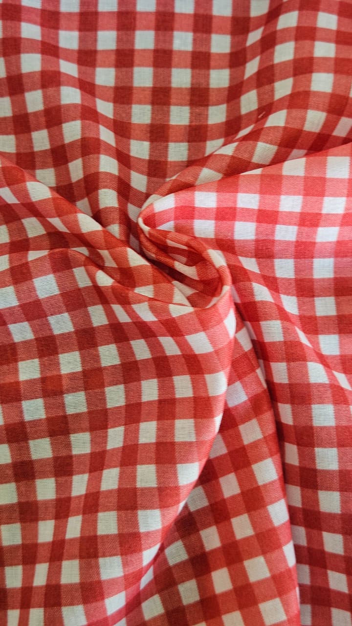 Close-up of soft, wrinkled pink cotton fabric displaying fine weave texture.