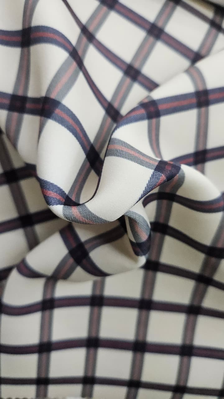 Close-up of soft, wrinkled pink cotton fabric displaying fine weave texture.
