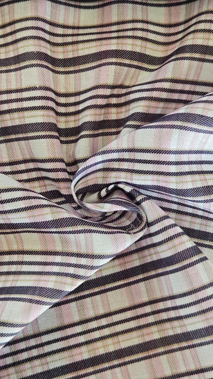 Close-up of soft, wrinkled pink cotton fabric displaying fine weave texture.