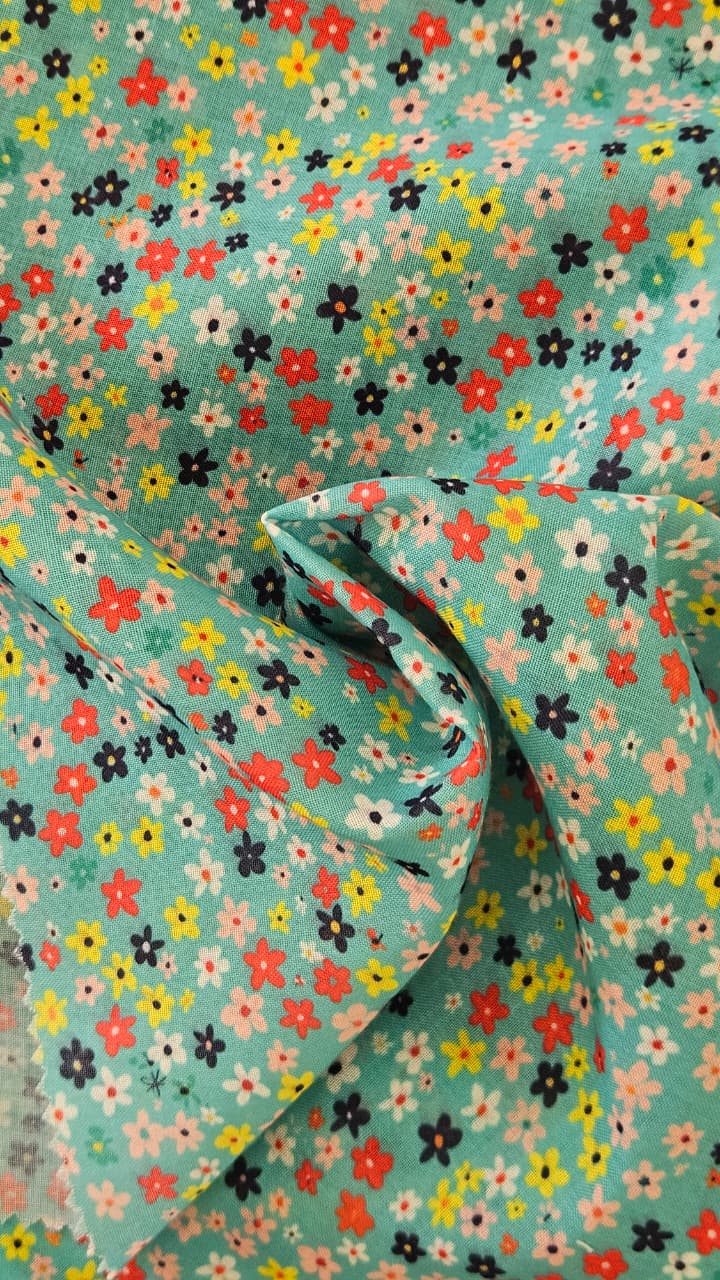 Close-up of soft, wrinkled pink cotton fabric displaying fine weave texture.