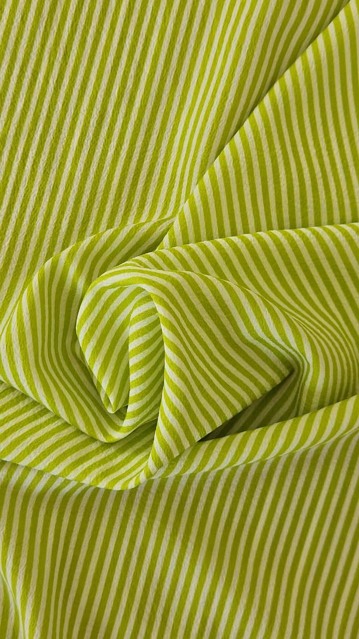 Close-up of soft, wrinkled pink cotton fabric displaying fine weave texture.