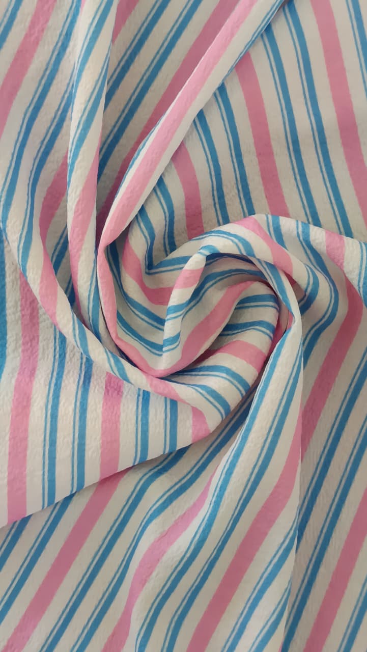 Close-up of soft, wrinkled pink cotton fabric displaying fine weave texture.