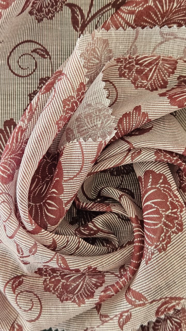 Close-up of soft, wrinkled pink cotton fabric displaying fine weave texture.