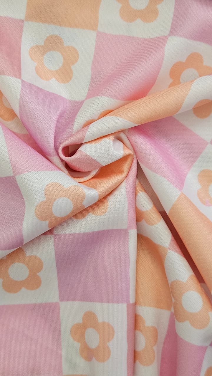 Close-up of soft, wrinkled pink cotton fabric displaying fine weave texture.