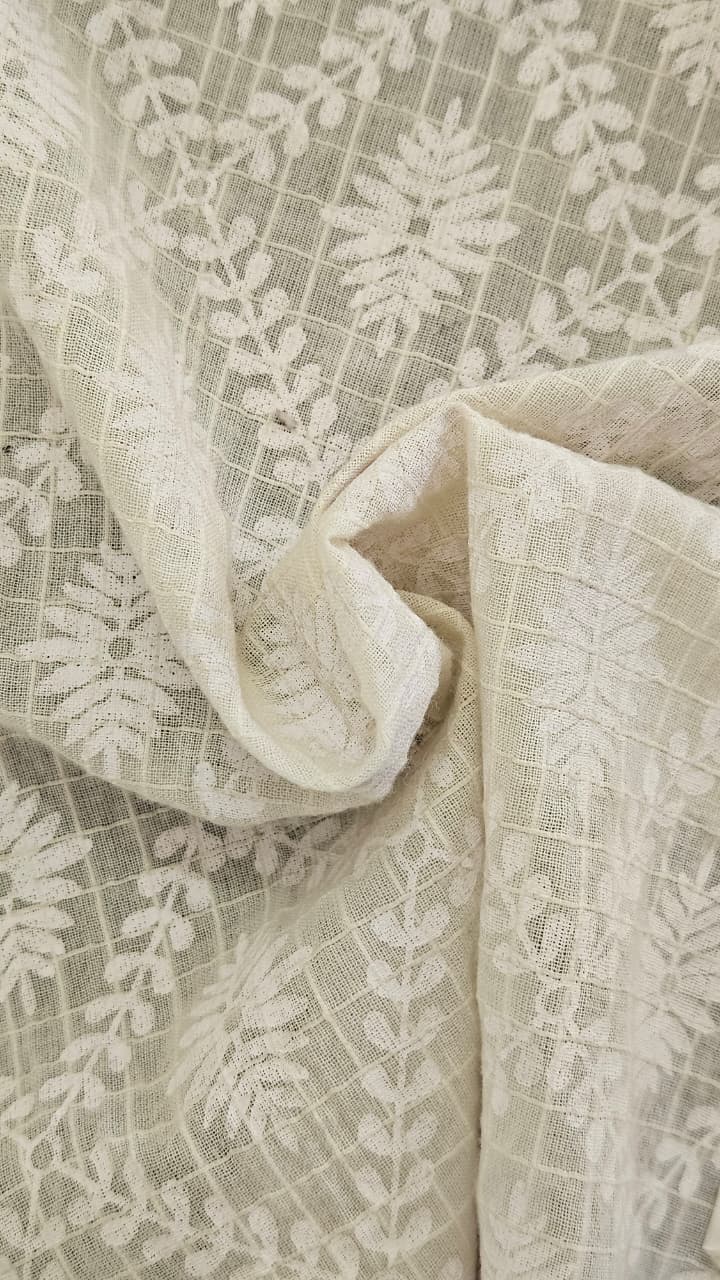 Close-up of soft, wrinkled pink cotton fabric displaying fine weave texture.