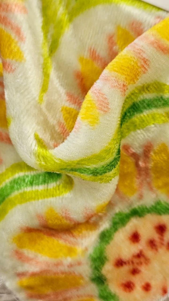 Close-up of soft, wrinkled pink cotton fabric displaying fine weave texture.
