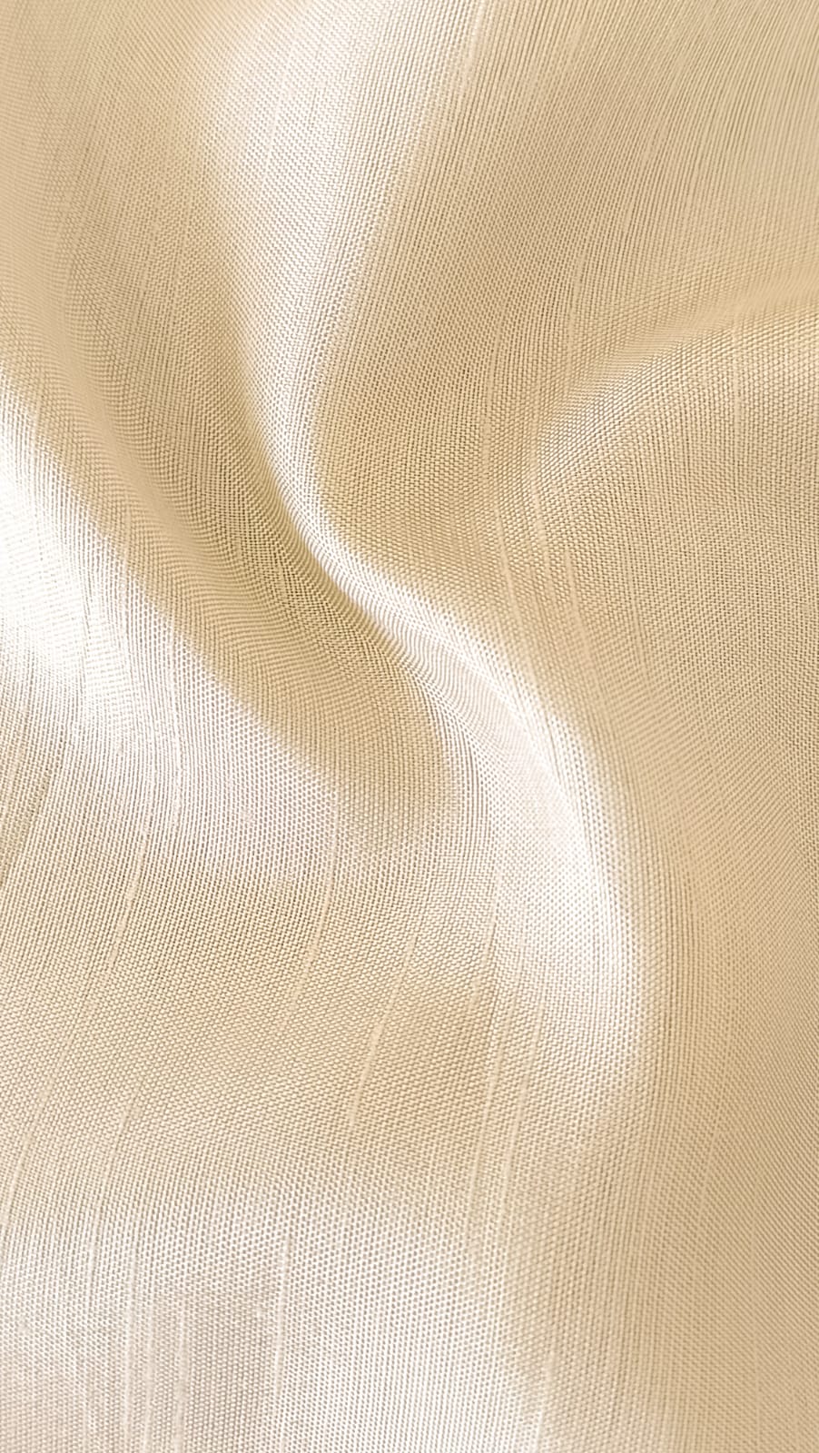 Close-up of soft, wrinkled pink cotton fabric displaying fine weave texture.