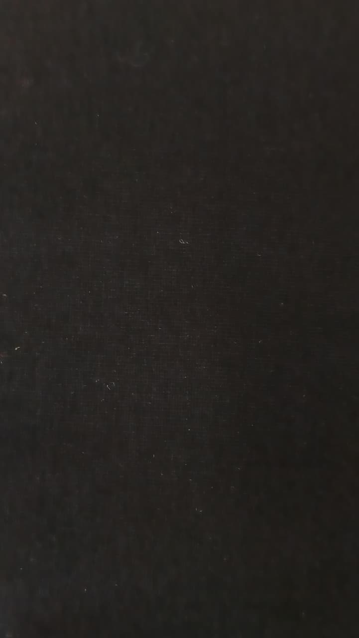Close-up of soft, wrinkled pink cotton fabric displaying fine weave texture.