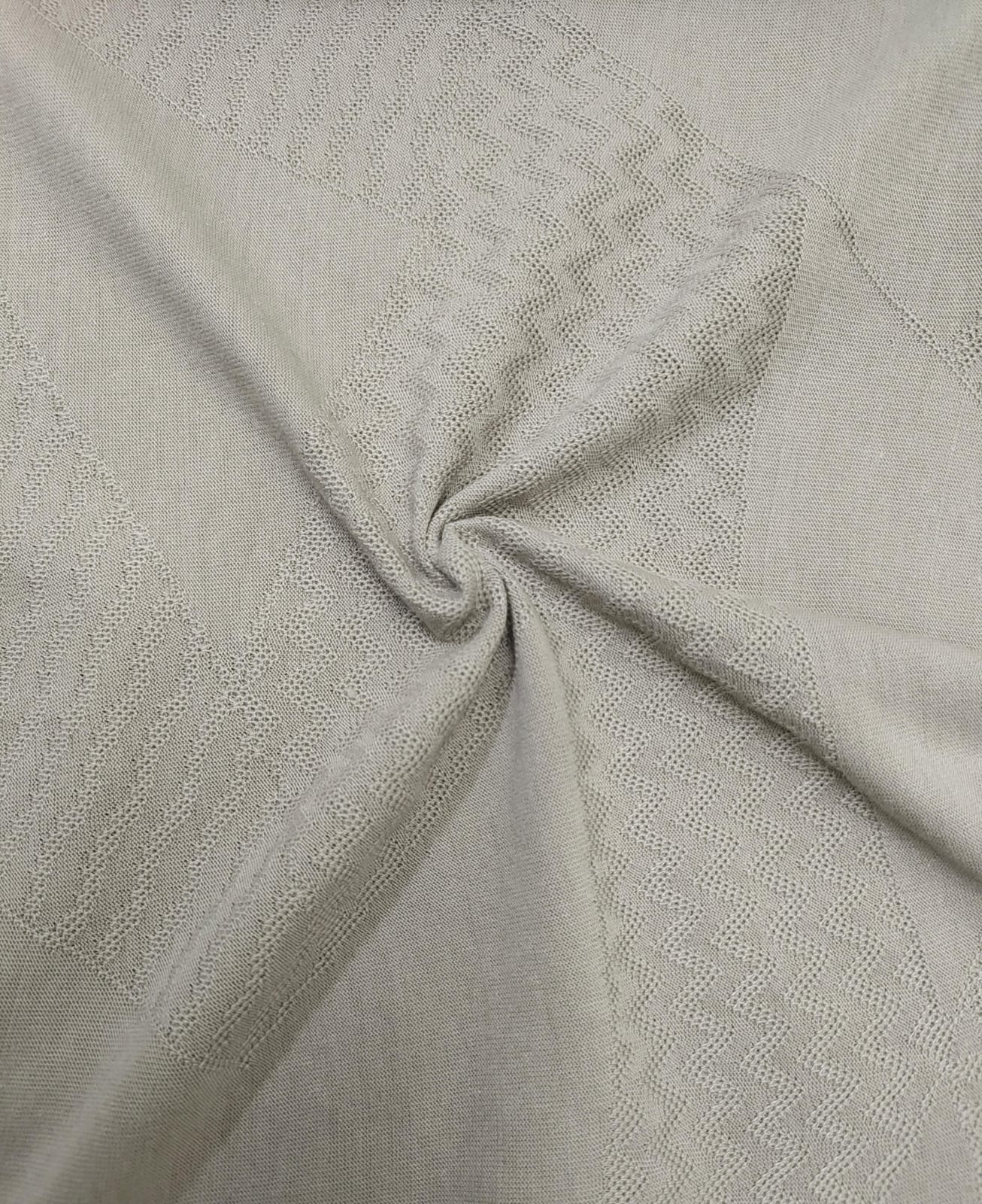 Close-up of soft, wrinkled pink cotton fabric displaying fine weave texture.