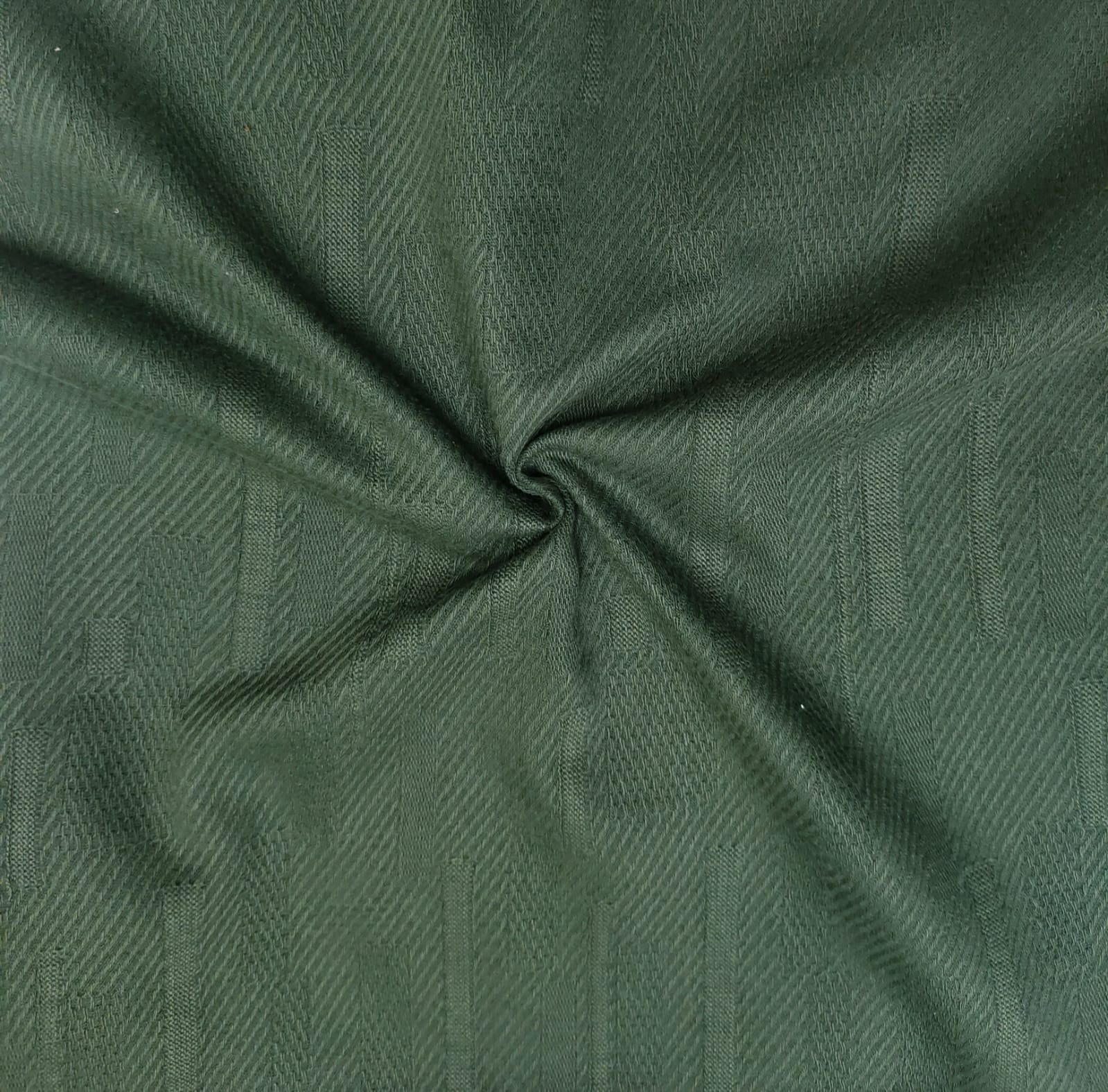 Close-up of soft, wrinkled pink cotton fabric displaying fine weave texture.
