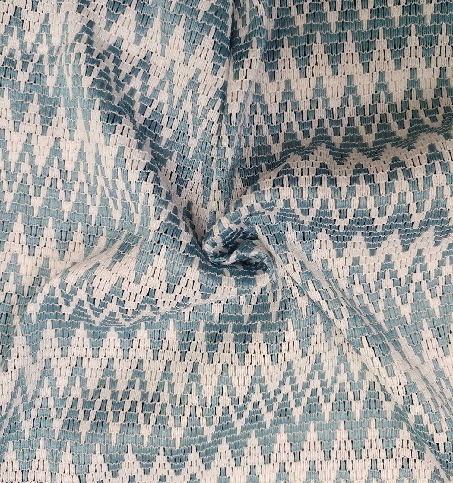 Close-up of soft, wrinkled pink cotton fabric displaying fine weave texture.