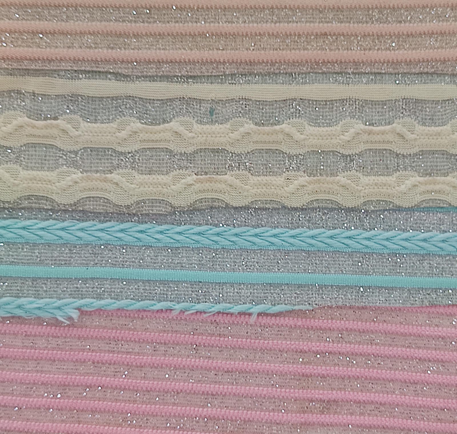 Close-up of soft, wrinkled pink cotton fabric displaying fine weave texture.