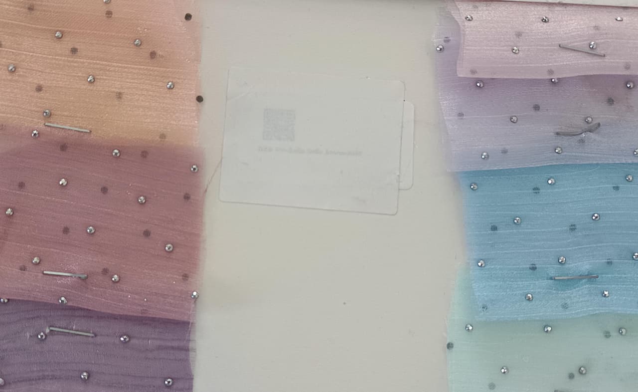 Close-up of soft, wrinkled pink cotton fabric displaying fine weave texture.