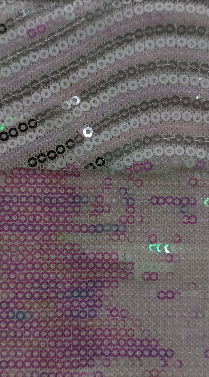 Close-up of soft, wrinkled pink cotton fabric displaying fine weave texture.