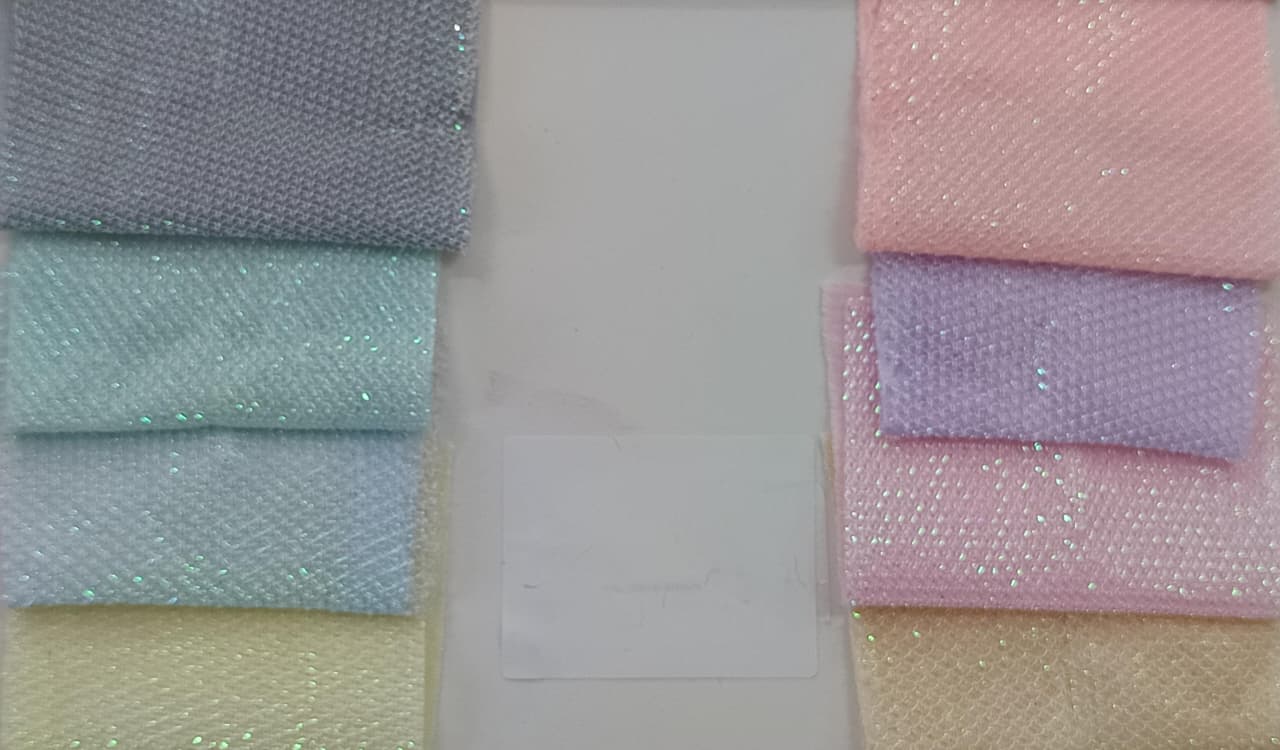 Close-up of soft, wrinkled pink cotton fabric displaying fine weave texture.