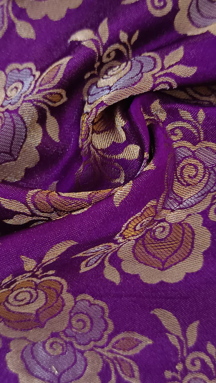 Close-up of soft, wrinkled pink cotton fabric displaying fine weave texture.