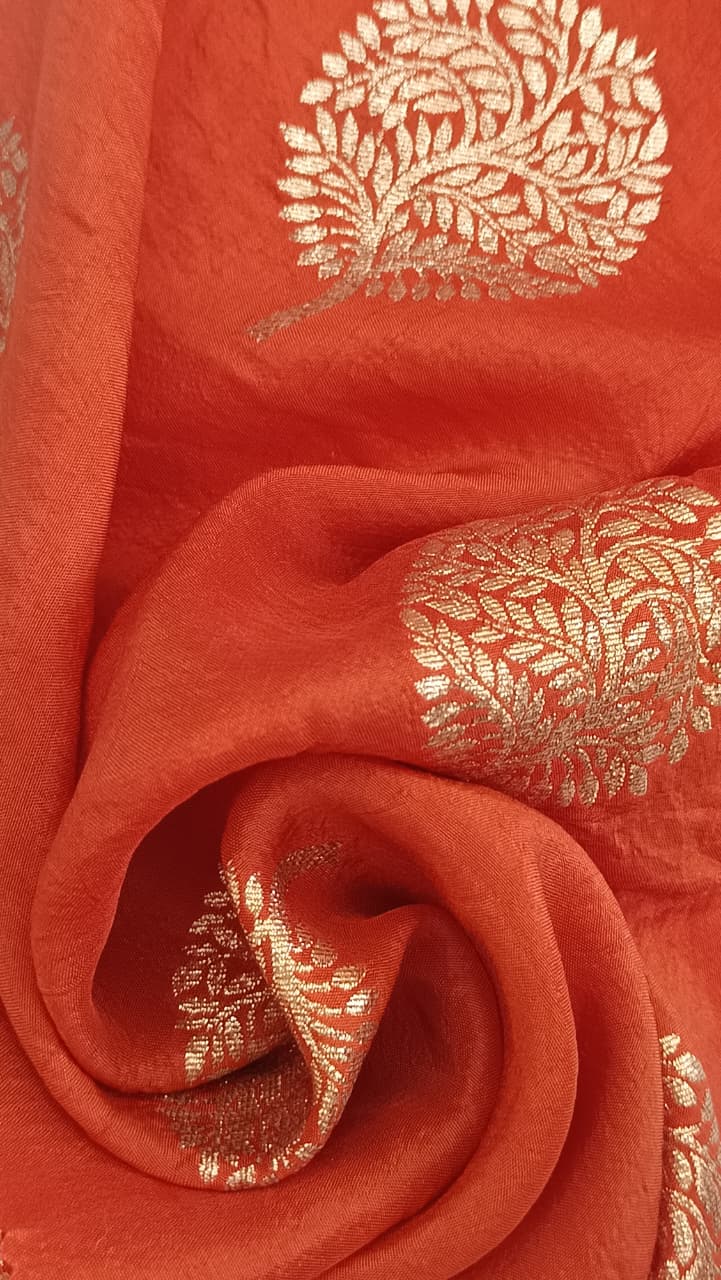 Close-up of soft, wrinkled pink cotton fabric displaying fine weave texture.