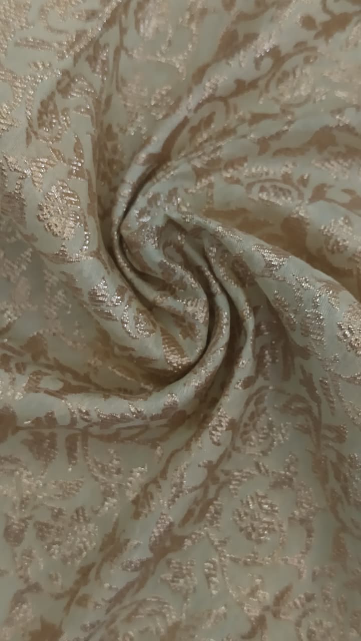 Close-up of soft, wrinkled pink cotton fabric displaying fine weave texture.