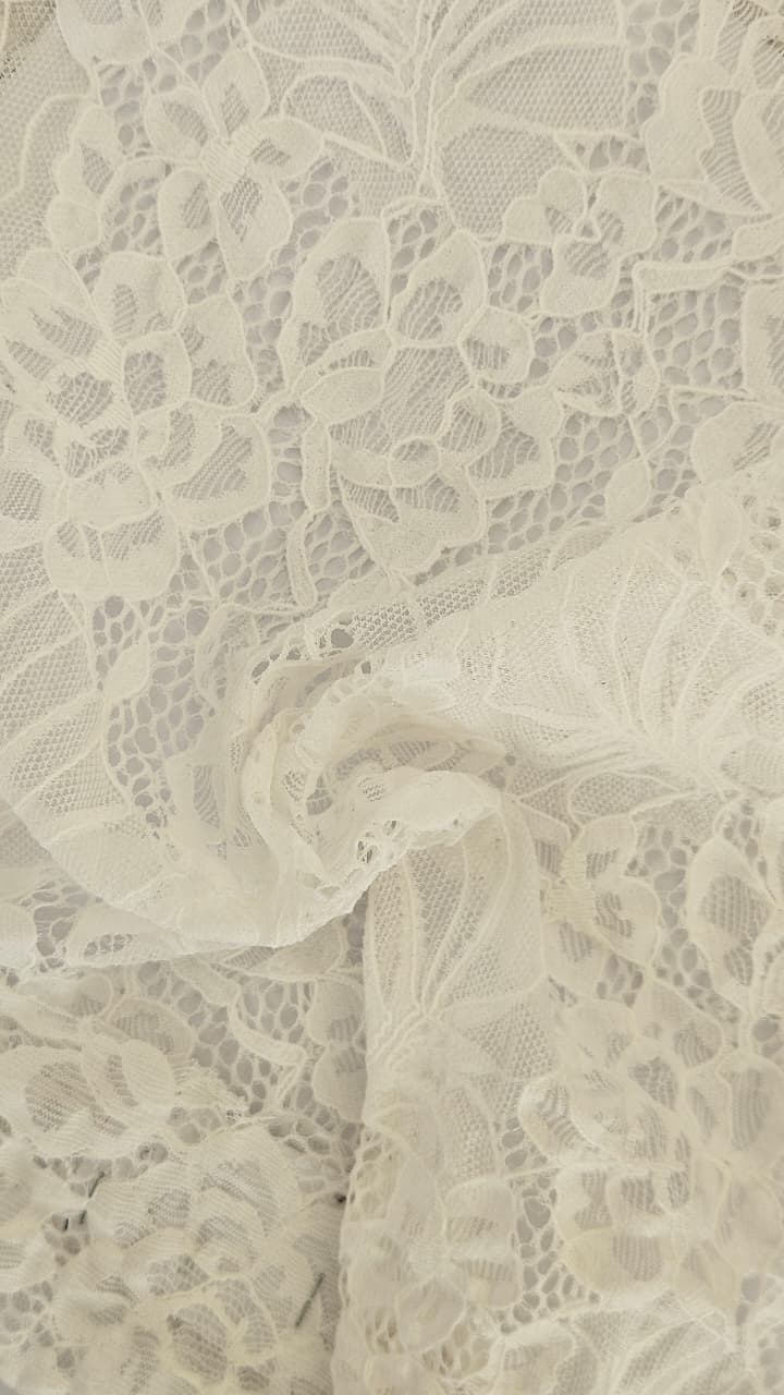 Close-up of soft, wrinkled pink cotton fabric displaying fine weave texture.