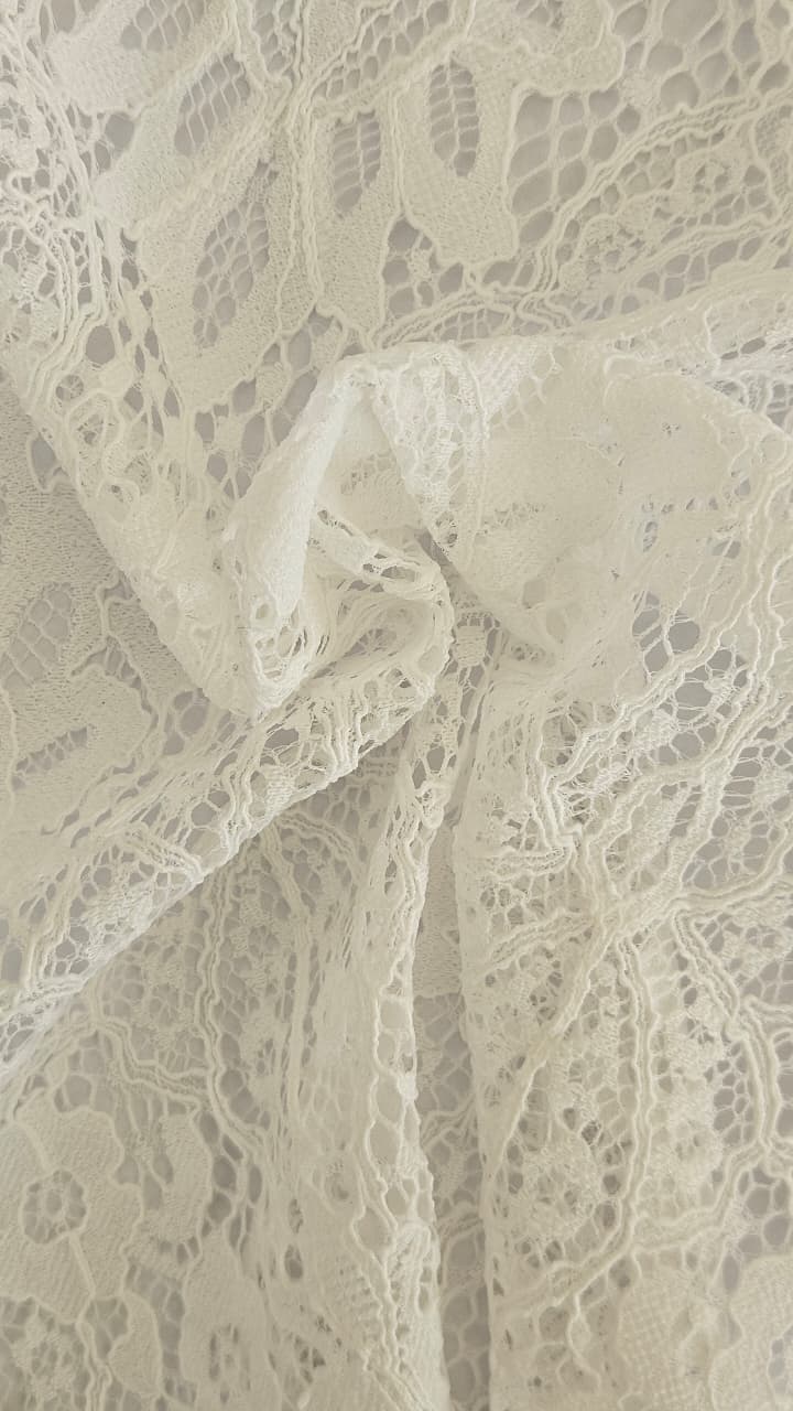 Close-up of soft, wrinkled pink cotton fabric displaying fine weave texture.