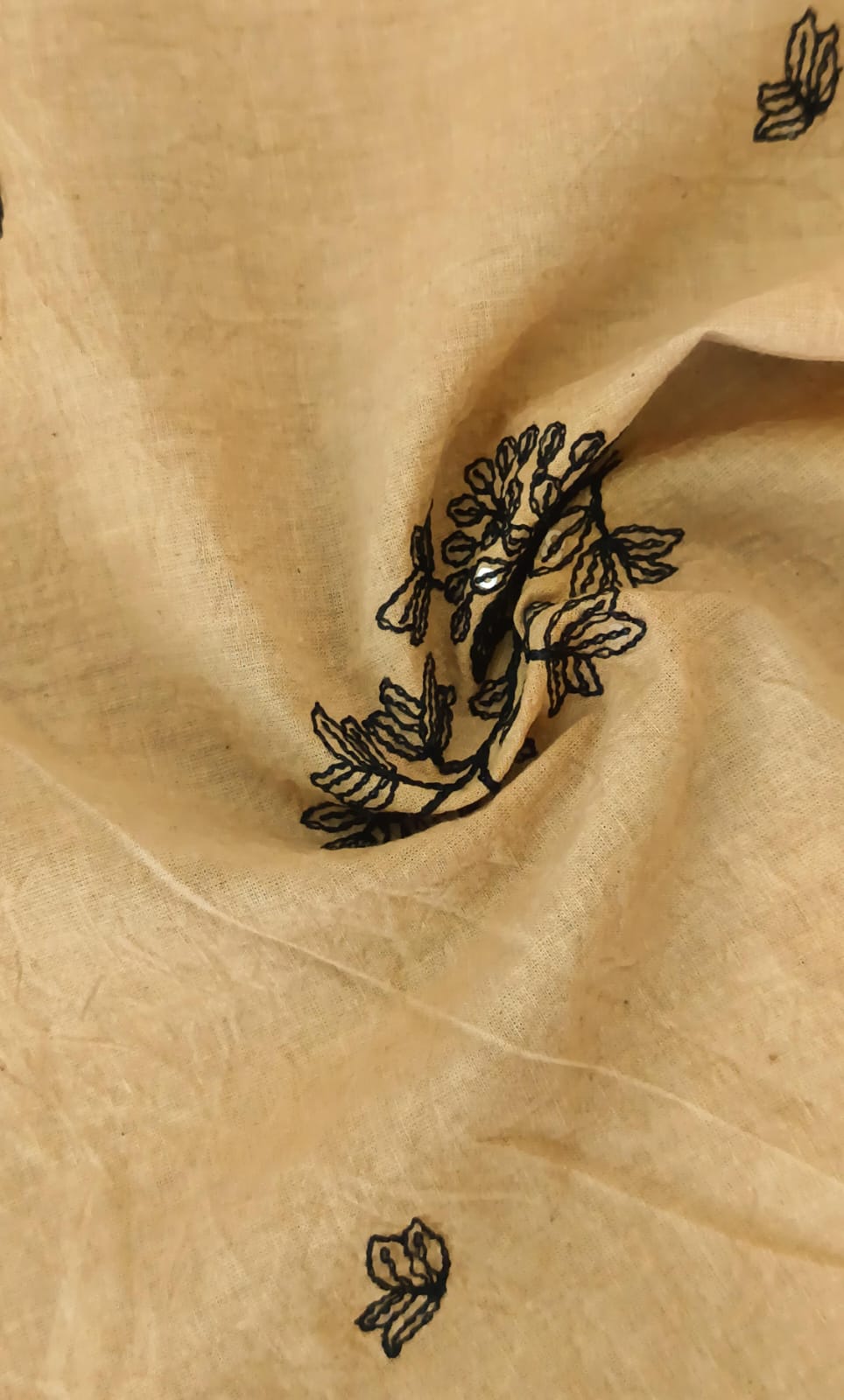 Close-up of soft, wrinkled pink cotton fabric displaying fine weave texture.