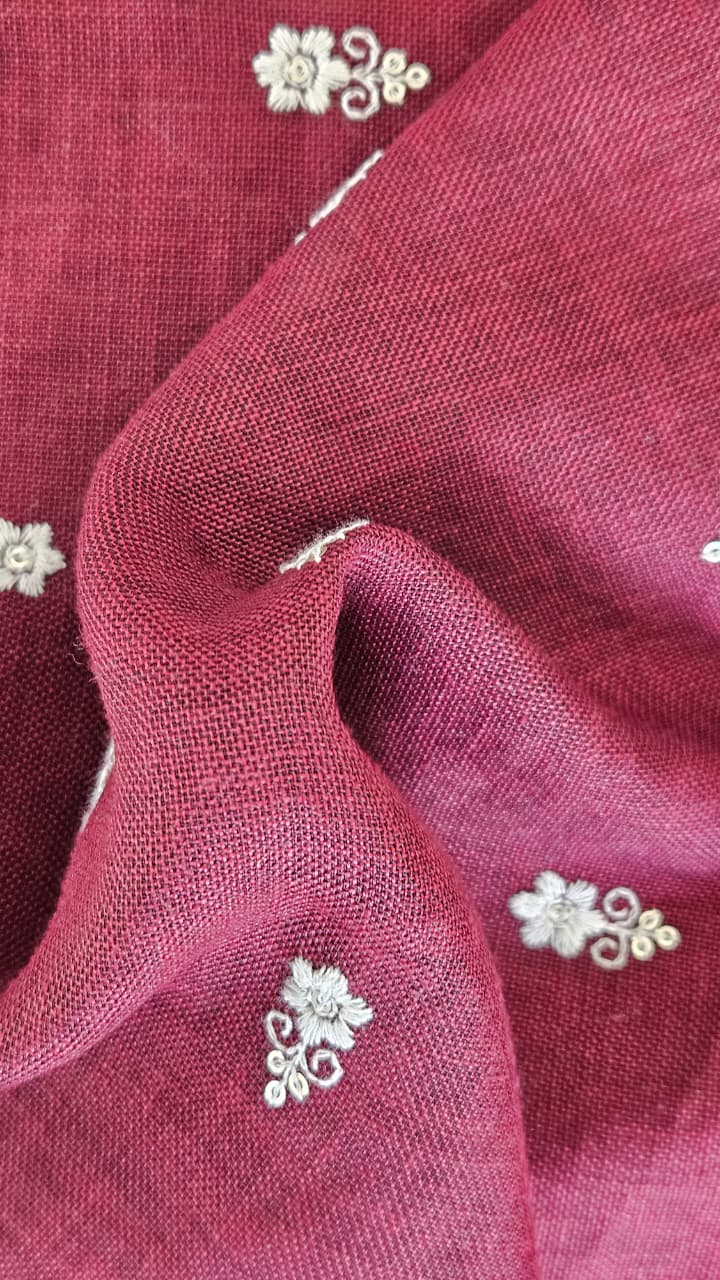 Close-up of soft, wrinkled pink cotton fabric displaying fine weave texture.