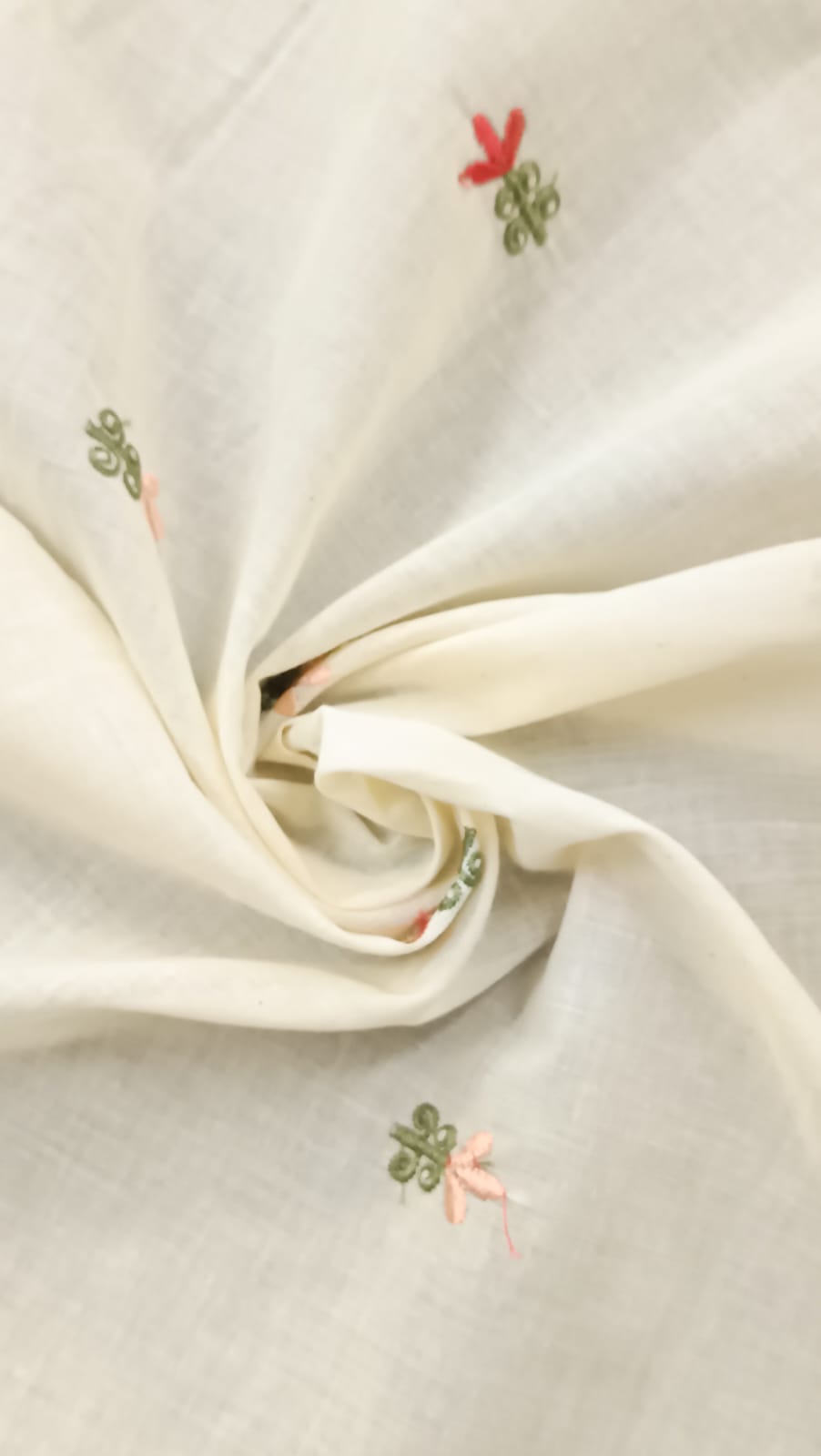 Close-up of soft, wrinkled pink cotton fabric displaying fine weave texture.