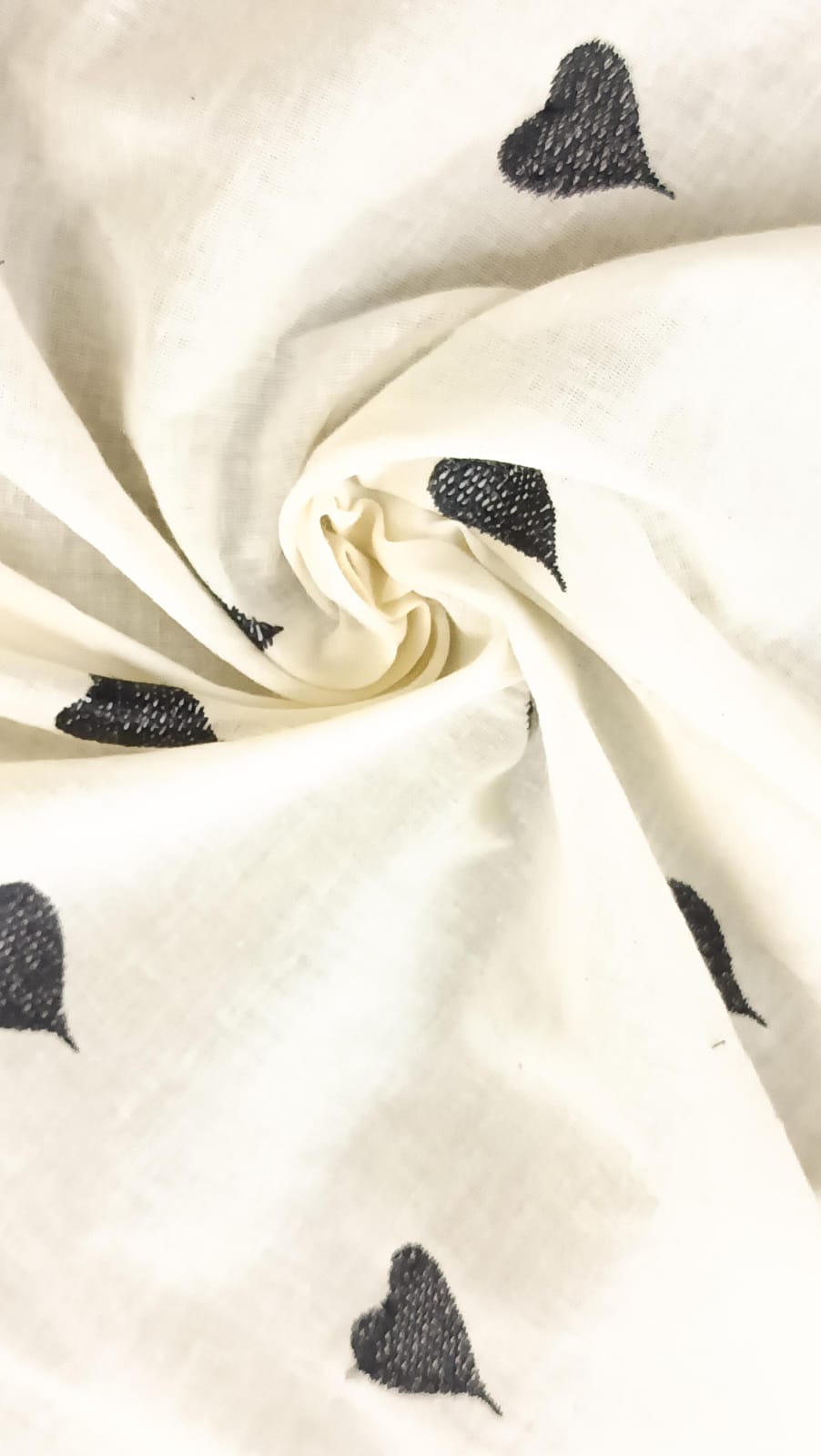 Close-up of soft, wrinkled pink cotton fabric displaying fine weave texture.