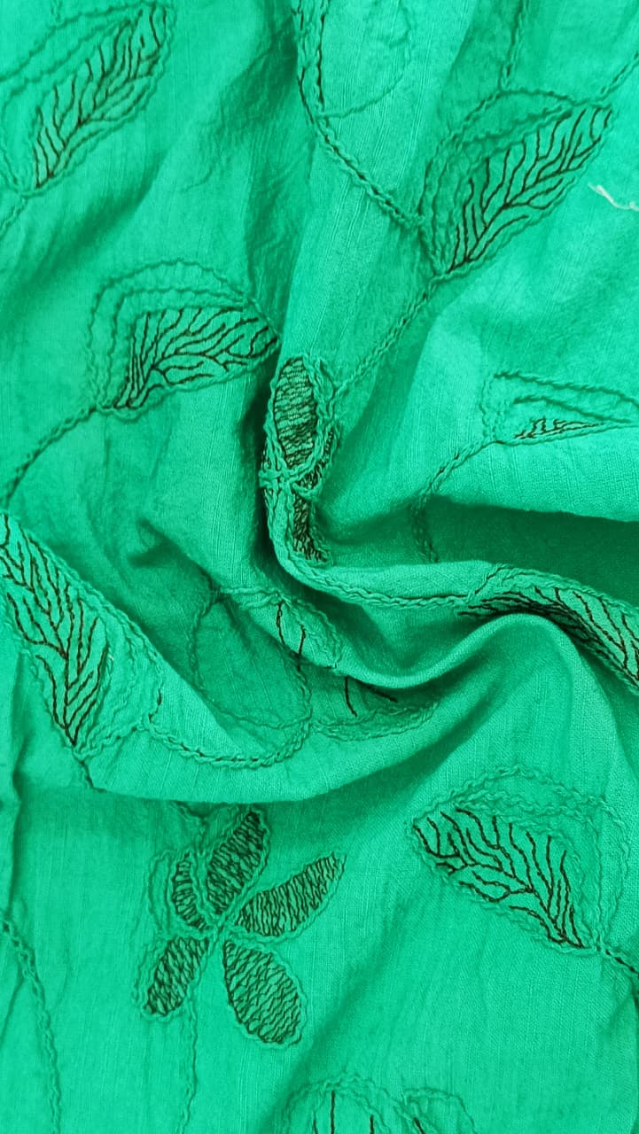 Close-up of soft, wrinkled pink cotton fabric displaying fine weave texture.