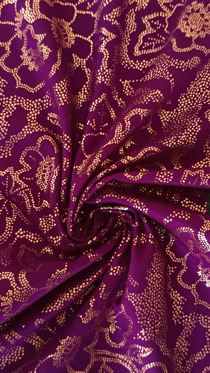 Close-up of soft, wrinkled pink cotton fabric displaying fine weave texture.