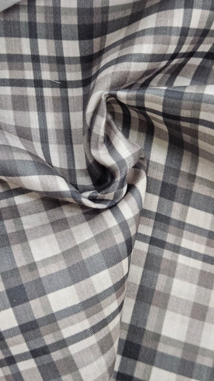 Close-up of soft, wrinkled pink cotton fabric displaying fine weave texture.