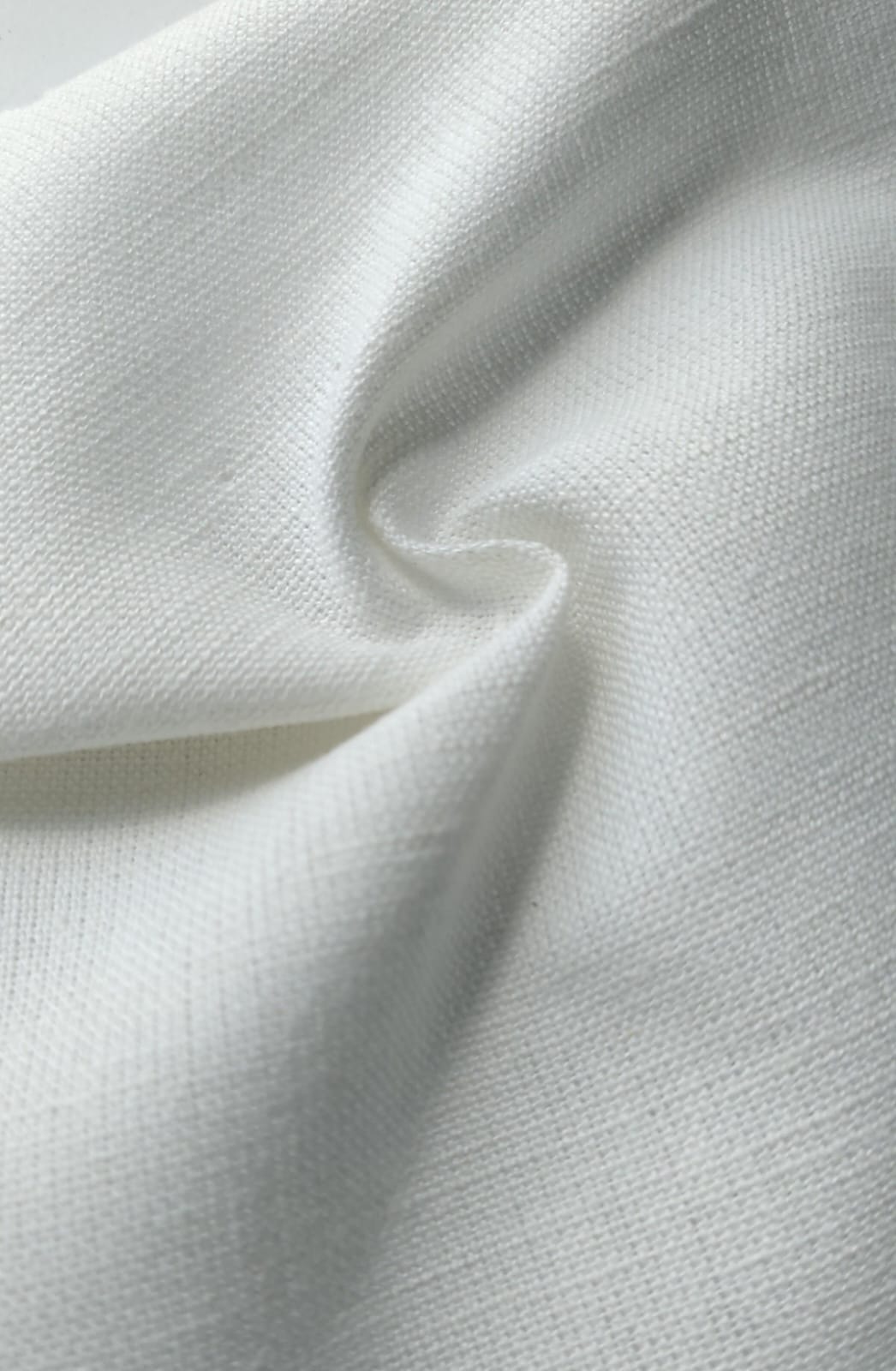 Close-up of soft, wrinkled pink cotton fabric displaying fine weave texture.