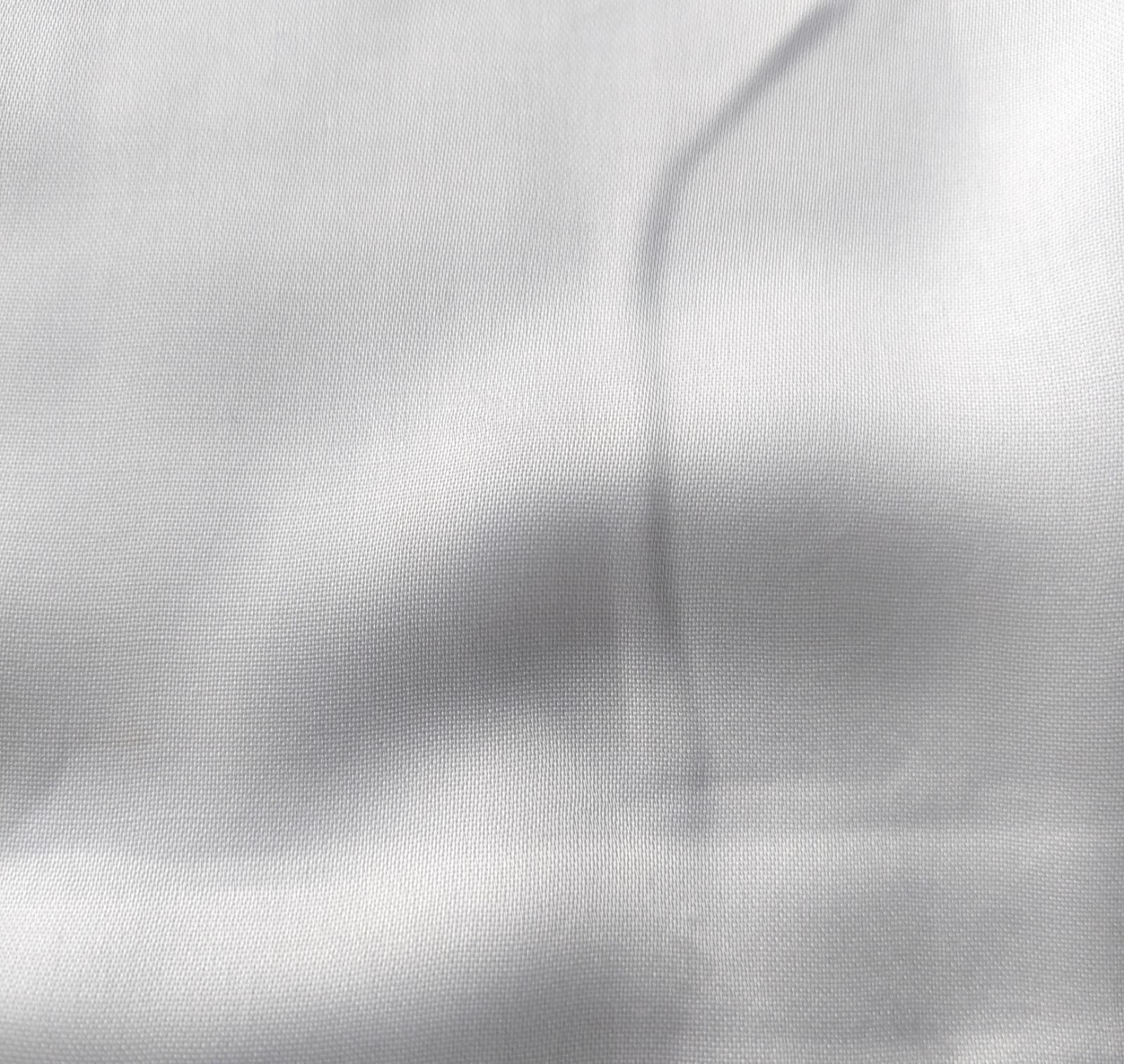 Close-up of soft, wrinkled pink cotton fabric displaying fine weave texture.