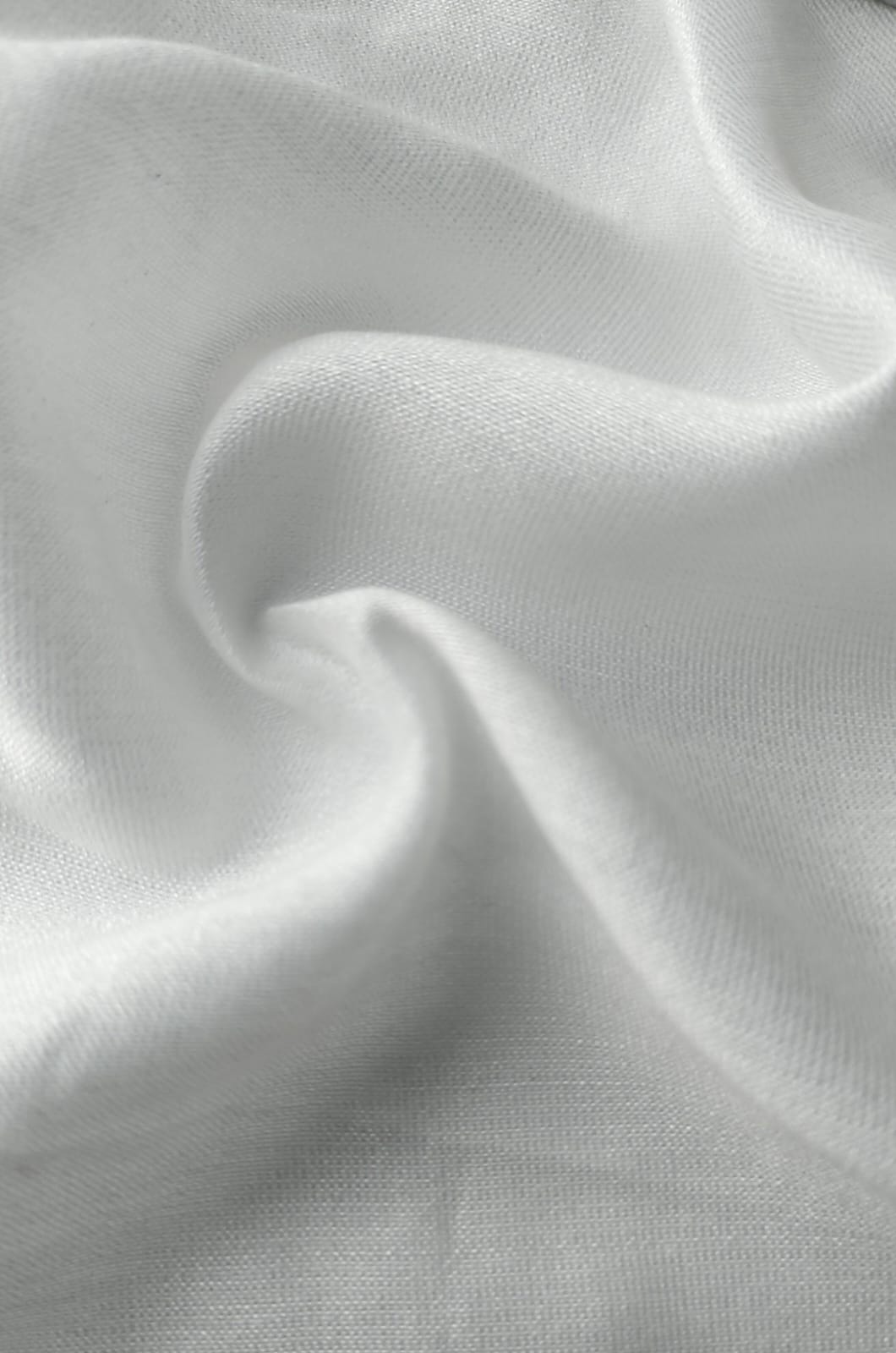 Close-up of soft, wrinkled pink cotton fabric displaying fine weave texture.