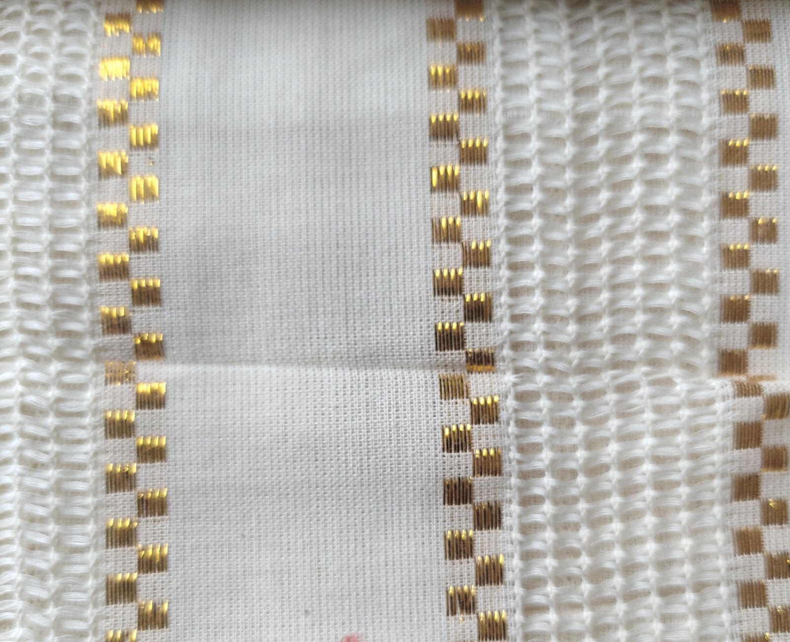 Close-up of soft, wrinkled pink cotton fabric displaying fine weave texture.