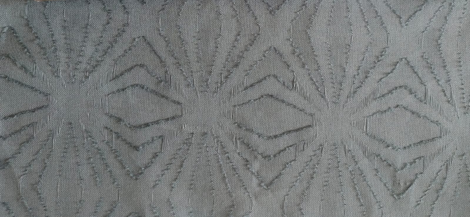 Close-up of soft, wrinkled pink cotton fabric displaying fine weave texture.