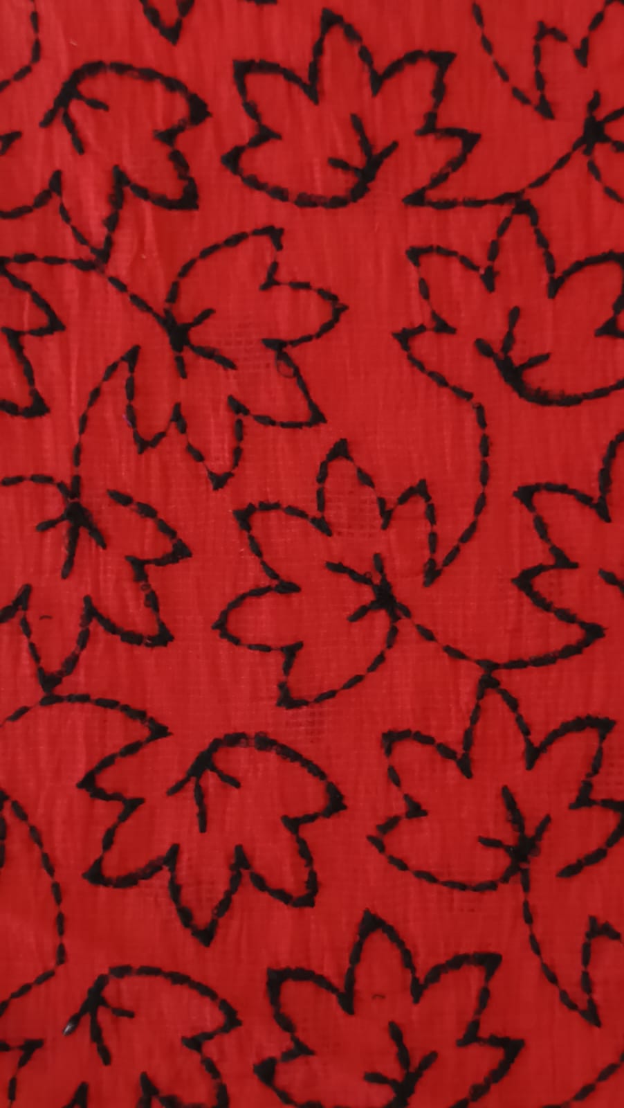 Close-up of soft, wrinkled pink cotton fabric displaying fine weave texture.