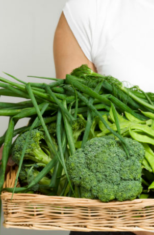 Fresh green vegetables in a woven basket