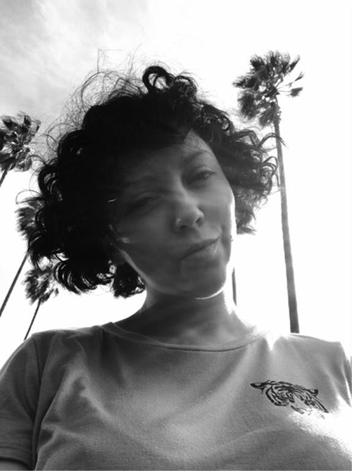 Kate, Davka Design founder, outdoors under palm trees