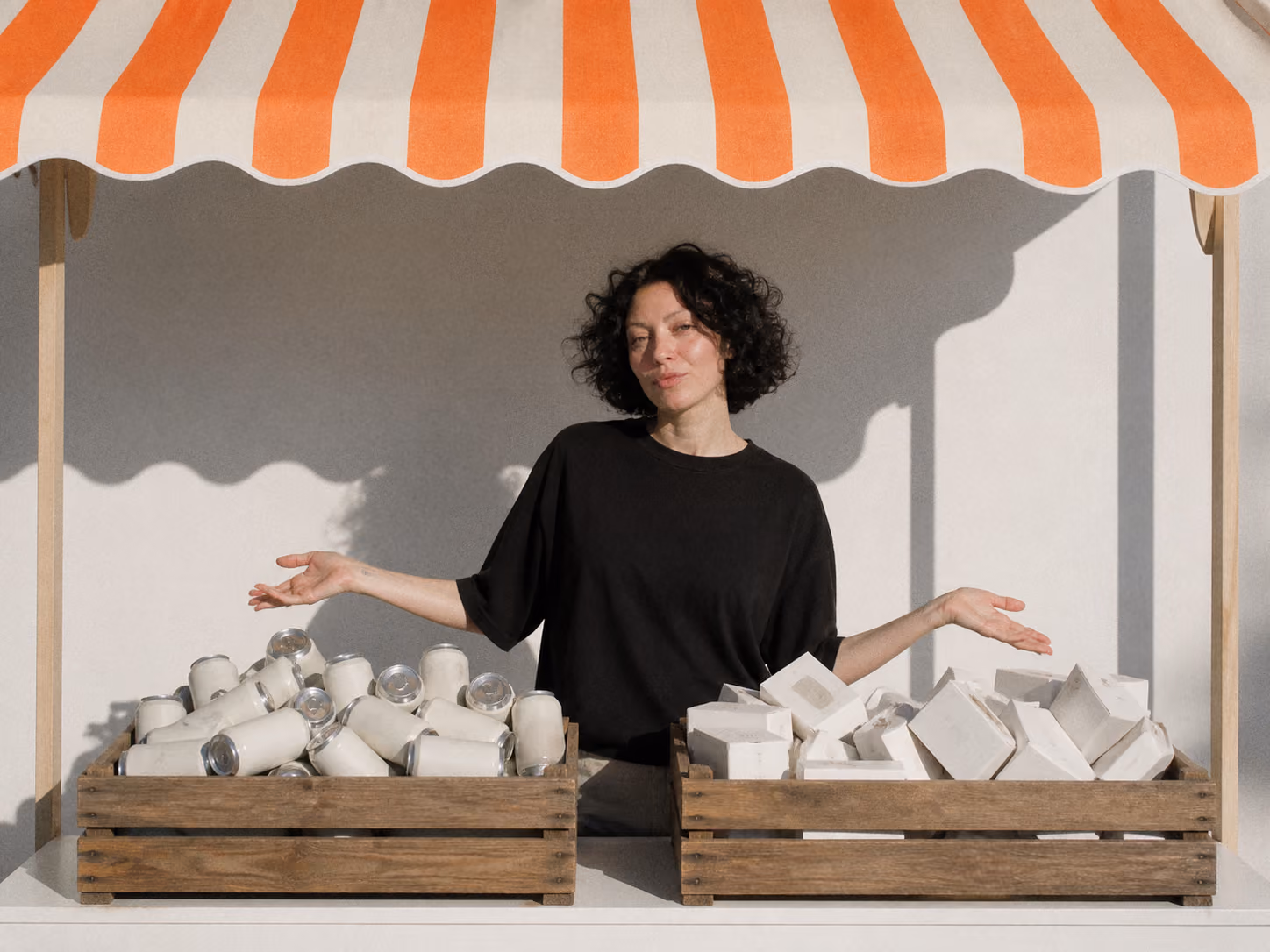 Kate, Davka Design founder, behind a market stall display