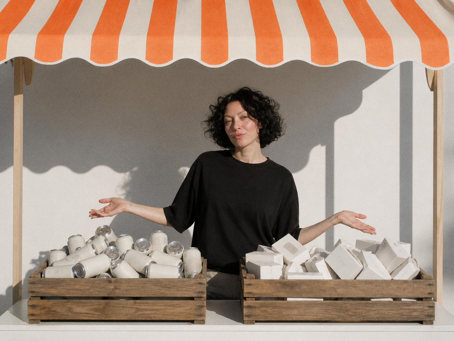 Kate, Davka Design founder, behind a market stall display