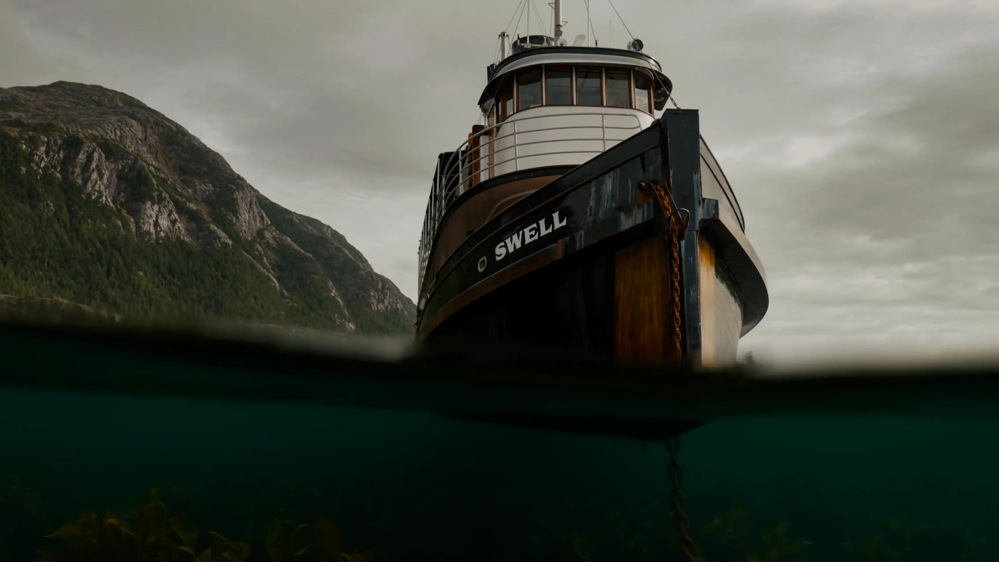 The Swell is a historic 88-foot Canadian tugboat built in 1912 by Arthur Moscrop for the Victoria Tug Company—the very same year the RMS Titanic set sail. Originally operating as a coal-fired steam vessel, it spent 92 years transporting vital cargo like wood and machinery along the rugged coast of British Columbia. Over its near-century as a commercial workboat, it underwent major transformations, including converting to a diesel engine in 1954, serving as a private yacht, and appearing on the classic Canadian TV show The Beachcombers in 1974. Following extensive multi-million dollar refits, this iconic wooden-hulled vessel was beautifully repurposed by Maple Leaf Adventures as a boutique, eco-friendly expedition cruise ship. Today, it accommodates up to 12 guests in private cabins, charting passenger excursions through the remote wilderness, fjords, and wildlife habitats of British Columbia and Alaska's Inside Passage