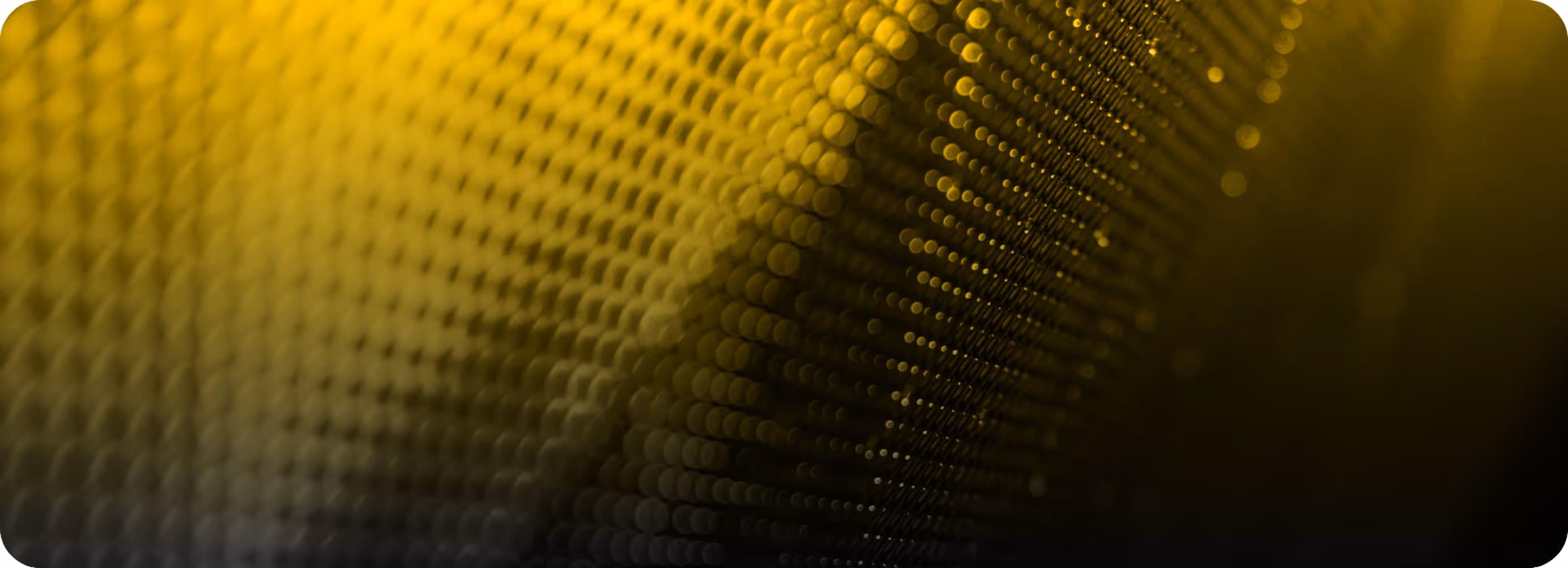 Abstract close-up of yellow and black textured pattern with round bokeh lighting effect.